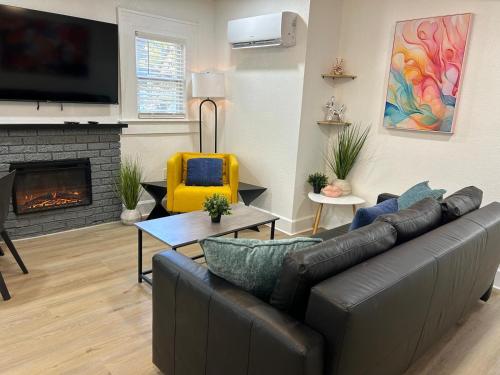 a living room with a couch and a fireplace at Downtown Zen 2-Bedrooms Private Bungalow in St. Petersburg