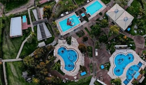 an aerial view of a resort with two swimming pools at Cabañas de Itacú in Chajarí