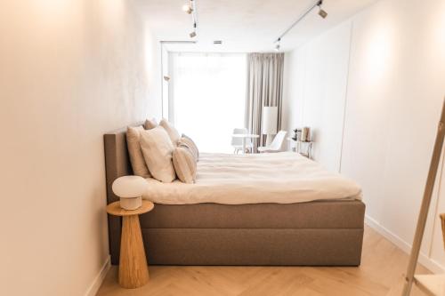 a bedroom with a large bed with a window at B&B s12 in Doetinchem