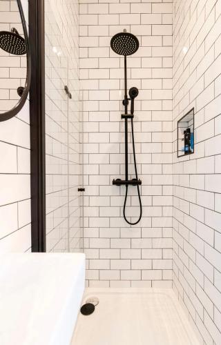 a white bathroom with a shower with a tub at Liberties Pre63 Studios in Dublin