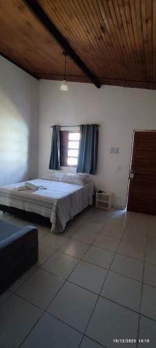 a bedroom with a bed and a window at Morada do vento in São Miguel do Gostoso