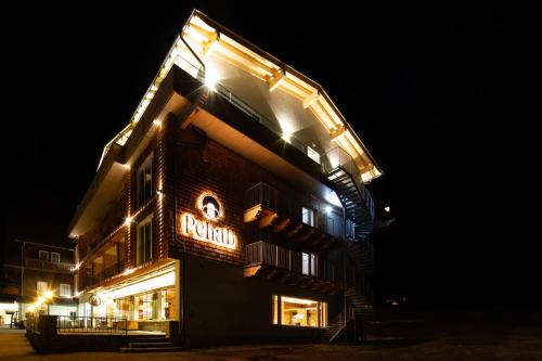 een gebouw met 's nachts een bord bij Aktivhotel Pehab - Dachstein Rooftop-Spa in Ramsau am Dachstein