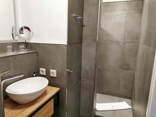 a bathroom with a shower and a white sink at Hotel & Spa Wasserschloss Westerburg in Westerburg