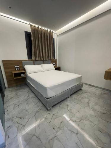 a bedroom with a large bed and a marble floor at Hôtel kairouan in Fez