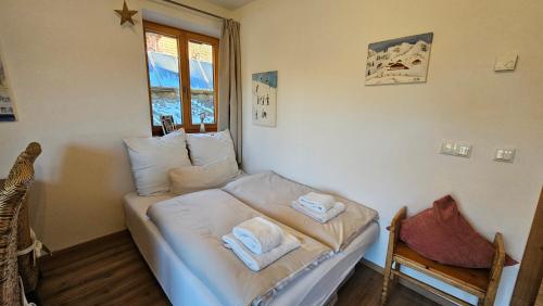 a room with a couch with towels on it at Mountain Suite Brixen in Brixen im Thale