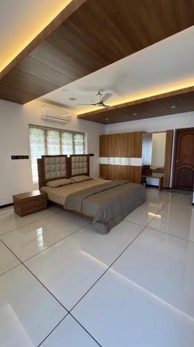 a bedroom with a large bed in a room at Krishnamadom in Kollam