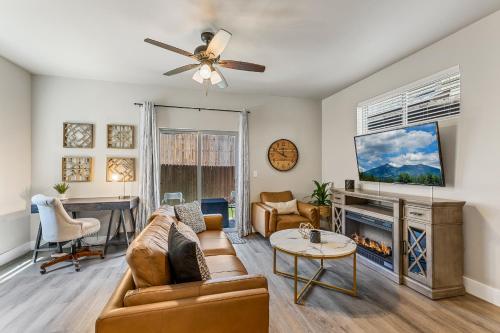 a living room with a couch and a tv at Serene Escape - Central to Grand Canyon and Sedona! in Flagstaff