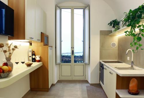 d'une cuisine avec évier et d'une porte avec fenêtre. dans l'établissement Casa Puglia Antica, à Castellana Grotte