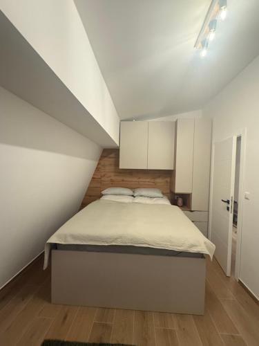 a bed in a room with white cabinets at Lunara Vlasic in Vlasic