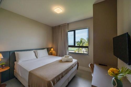 Postel nebo postele na pokoji v ubytování Pé na Areia com conforto | Vog Marine Ilhéus