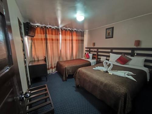 a hotel room with two beds and a window at SQ Estancia Del Inca in Cusco