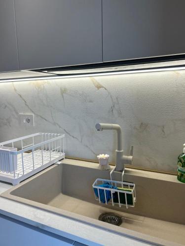 a sink with a faucet in a kitchen at Brezza di mare home con garage in Civitanova Marche