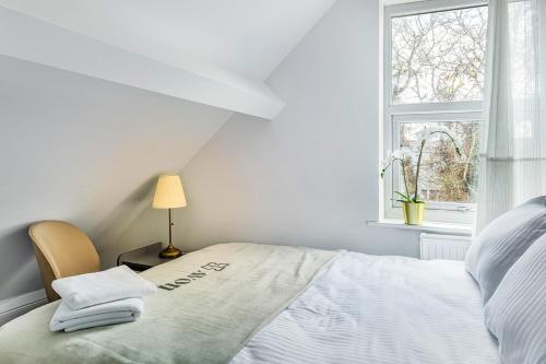 a white bedroom with a bed and a window at West Bridgford Comfort Quality Suites in Nottingham