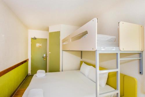 a small room with two bunk beds in it at ibis Budget Canberra in Canberra