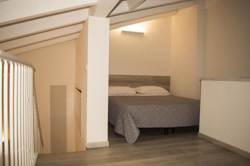 a bedroom with a bed in the corner of a room at Albergo Covili in Pavullo nel Frignano