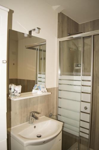 a bathroom with a sink and a shower at Albergo Covili in Pavullo nel Frignano