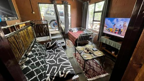 a room with two bunk beds and a tv in it at Zoko cottage in Maun