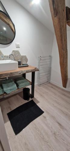 a room with a table and a wooden floor at Gîte de Dedette in La Grise
