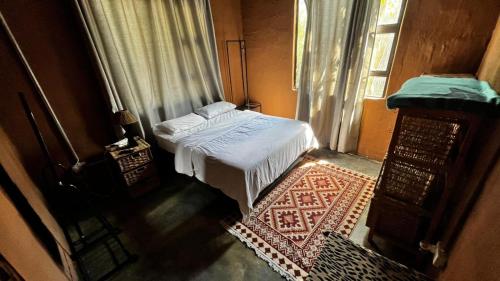a small bedroom with a bed and a window at Zoko cottage in Maun