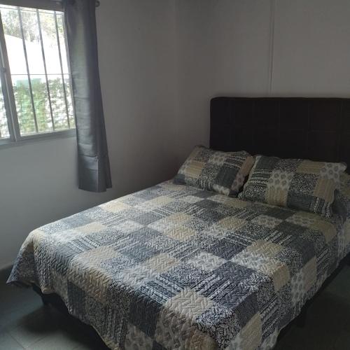 a bedroom with a bed with a quilt on it at La Olimareña in Treinta y Tres