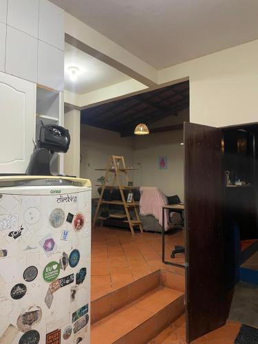 a kitchen with a refrigerator with magnets on it at Casa Kahlo in Lençóis