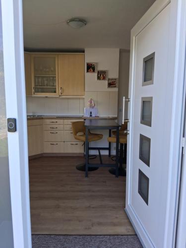 an open door to a kitchen with a table at Ferienwohnung Wolfsgarten in Rauschenberg