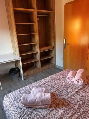 a bedroom with a bed with two towels on it at Coliving Leon in León