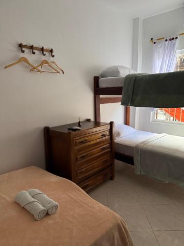 a bedroom with two bunk beds and a wooden dresser at Hotel Casa Colonial Moñitos in Moñitos