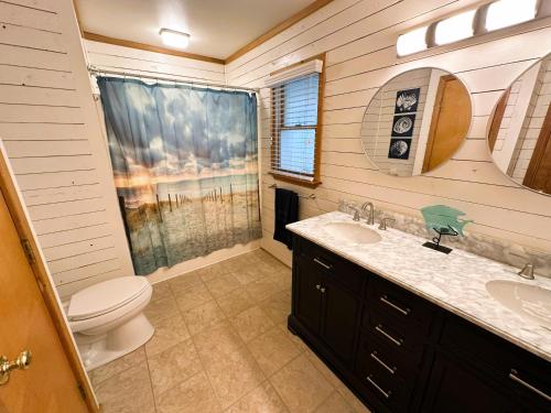 a bathroom with a toilet and a sink at D112-Happy Go Ducky in Duck
