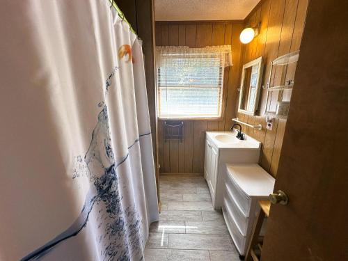 a bathroom with a shower curtain and a sink at SS303- Duck Hill in Southern Shores