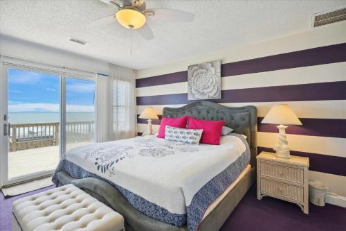 a bedroom with a large bed and a balcony at SS3 - Bella Luna in Southern Shores