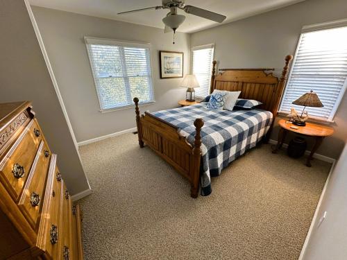 a bedroom with a bed and two windows at KH101 - Shells in Kitty Hawk