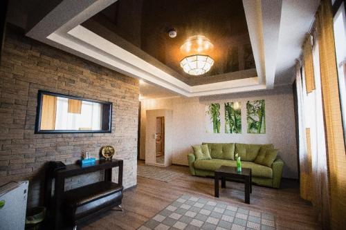a living room with a couch and a table at Park EmpAir Hotel in Pavlodar