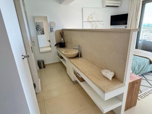 a bathroom with a counter with a sink in it at Luxury Lagada Loft Sea Views in Pilalímata
