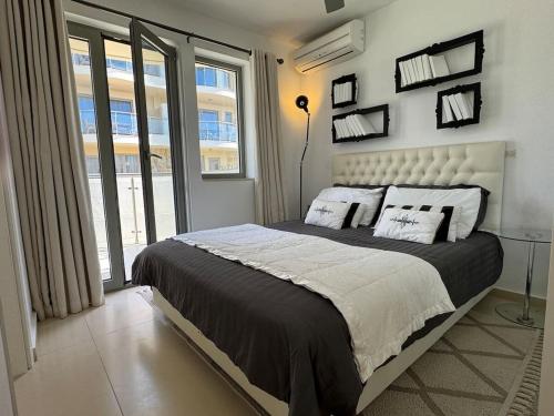 a bedroom with a large bed with pillows on it at Luxury Lagada Loft Sea Views in Pilalímata
