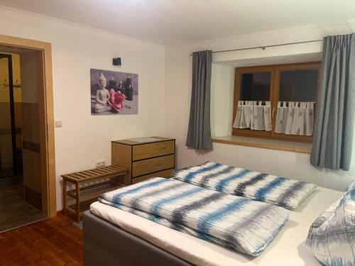 a small bedroom with a bed and a window at Landhaus Ganzer in Niedernsill