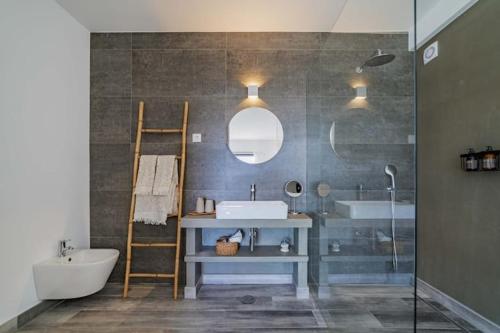 a bathroom with a sink and a tub and a mirror at Amazing Views Villa in Loulé