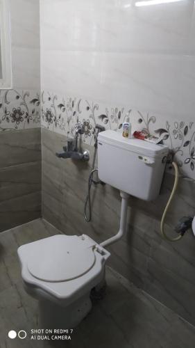 a bathroom with a toilet and a sink at Peacock Abode Farm in Bangalore