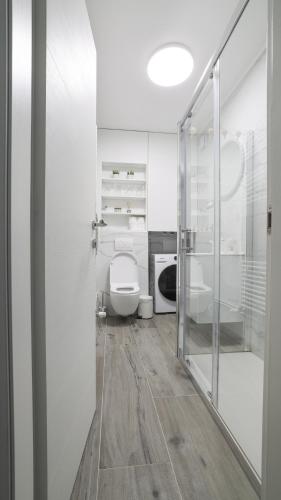 a bathroom with a toilet and a glass door at Apartman Lana in Plitvička Jezera