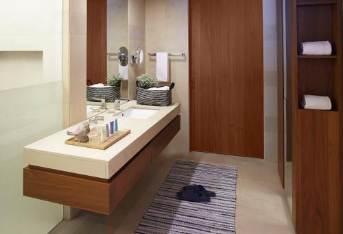a bathroom with a sink and a mirror at The Classic 500 Pentaz Executive Residence in Seoul
