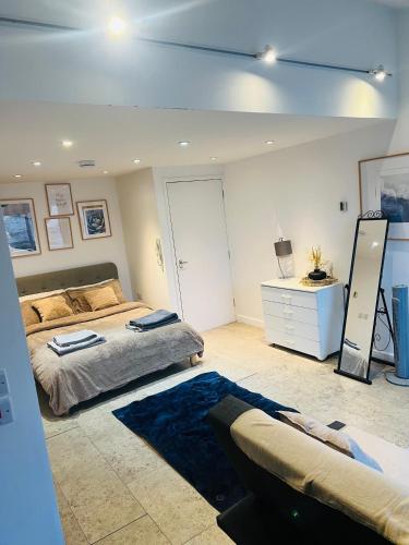 a large bedroom with two beds and a mirror at Riverlight Studio sleep 3 in Cambridge