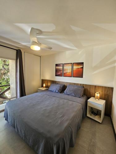 a bedroom with a large bed with two night stands at Go Eco Paradise Ap210 Pé na Areia e Piscina no Centro do Cumbuco in Caucaia