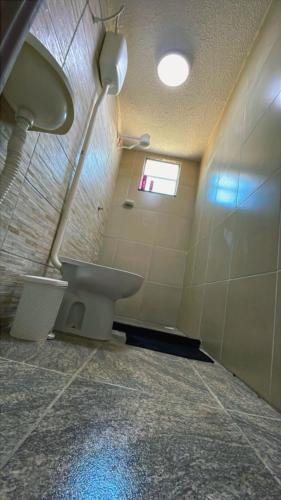 a bathroom with a sink and a toilet at Hostel Mariah in Cabo Frio