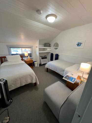 a large bedroom with two beds and a couch at Tofino Paddlers Inn in Tofino