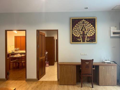 a room with a table and a picture on the wall at Aonang Peace Pool Villa in Ban Khlong Haeng