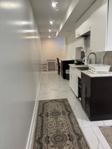a kitchen with white appliances and a rug on the floor at park inn in Toronto