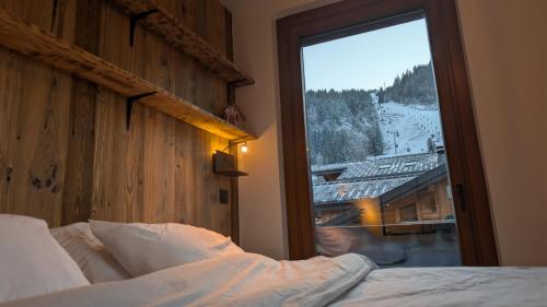 a bedroom with a window with a view of a mountain at Edelweiss Lodge in Morzine