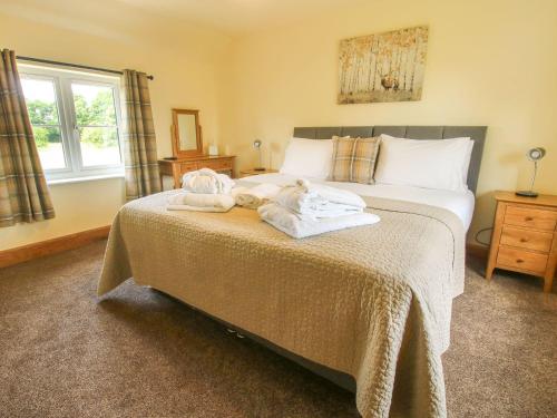 a bedroom with a bed with towels on it at 1 Clarkes Lane in Oswestry