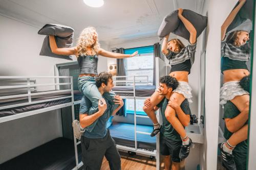 a group of people standing on a bunk bed at Mad Monkey Potts Point in Sydney