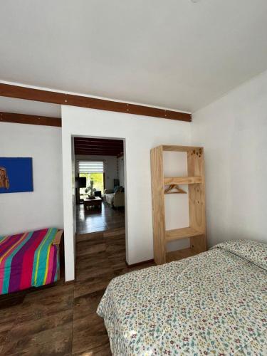 a bedroom with two beds and a room with a desk at Casa en Concon in Vina del Mar